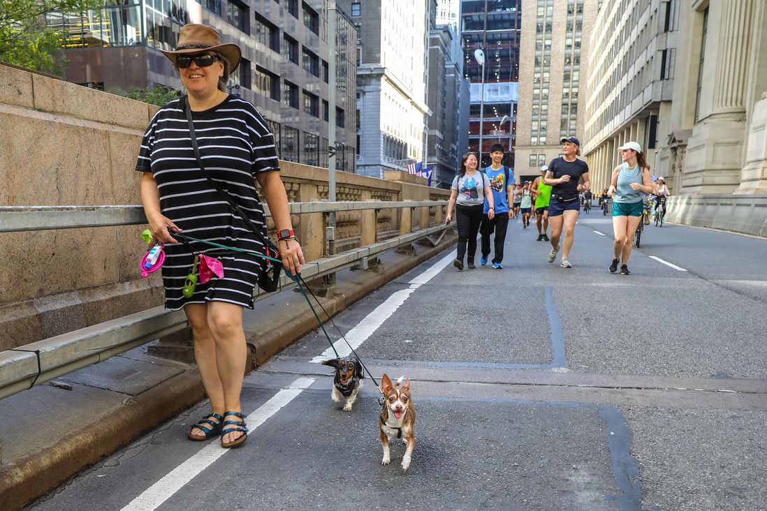 Images of people walking, running, skating and bicycling on vehicle-free city streets in Manhattan.
